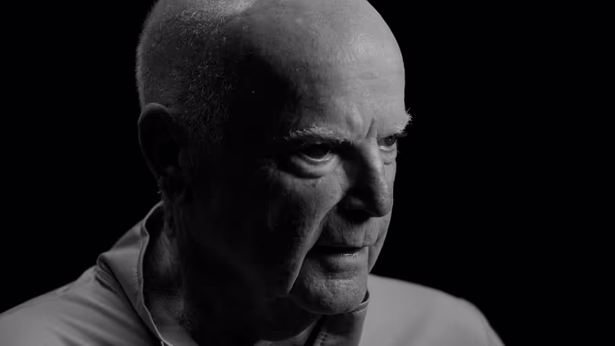 A picture of John in front of a black background